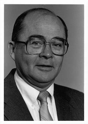 Black and white photo of Jim Laue where a suit and glasses.