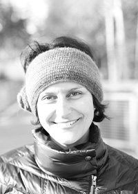 Black and white photo of Janine Elgamel wearing a hat outside.
