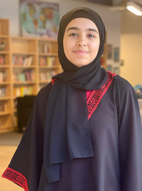 Insha Memon smiling and wearing hijab