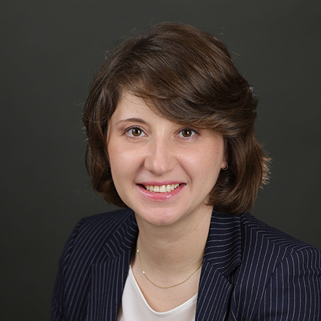 Olesya Vartanyan smiling, wearing professional attire