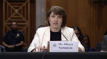 Olesya Vartanyan seated at a desk in the U.S. Congress giving testimony