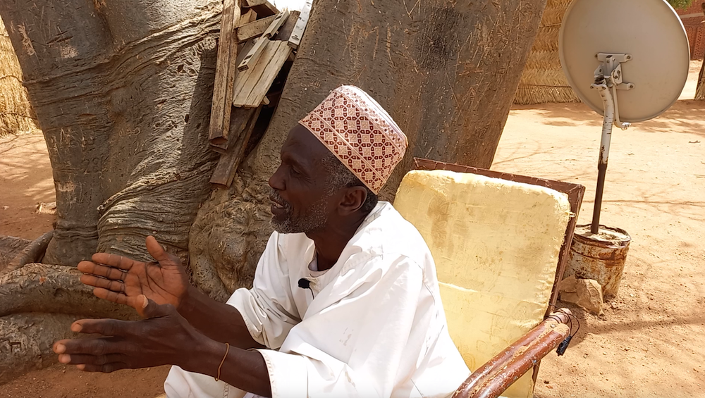 An interviewer engaged with a Sudanese civilian about their experiences in wars. Photo provided.