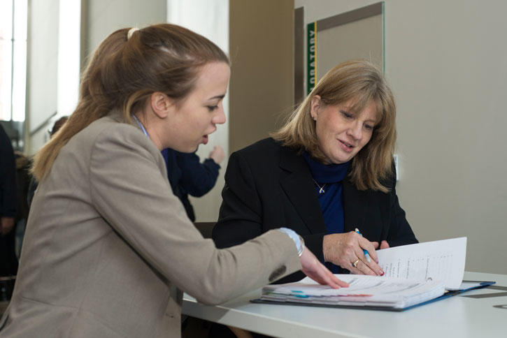 Carter School teacher Pamela Struss works with undergraduate student