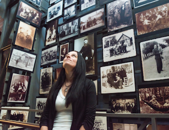 A woman looks up at walls of old pictures of Jewish individuals at the US Holocaust Memorial Museum in Washington DC.