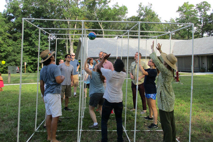 Students and Faculty playing a game akin to a cross between volleyball and tic-tac-toe