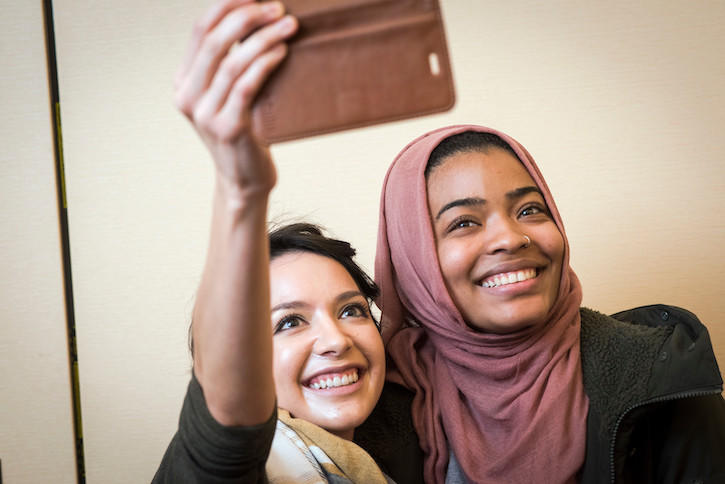 Two students point a selfie camera at themselves