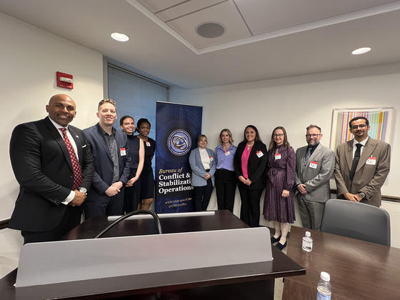 Group photo with students and Dr. Keith Noble around US Department of State banner