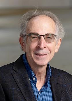 Daniel Rothbart smiling for a portrait photograph